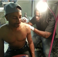 a man getting a tattoo in a tattoo shop