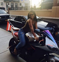 a woman sitting on a motorcycle